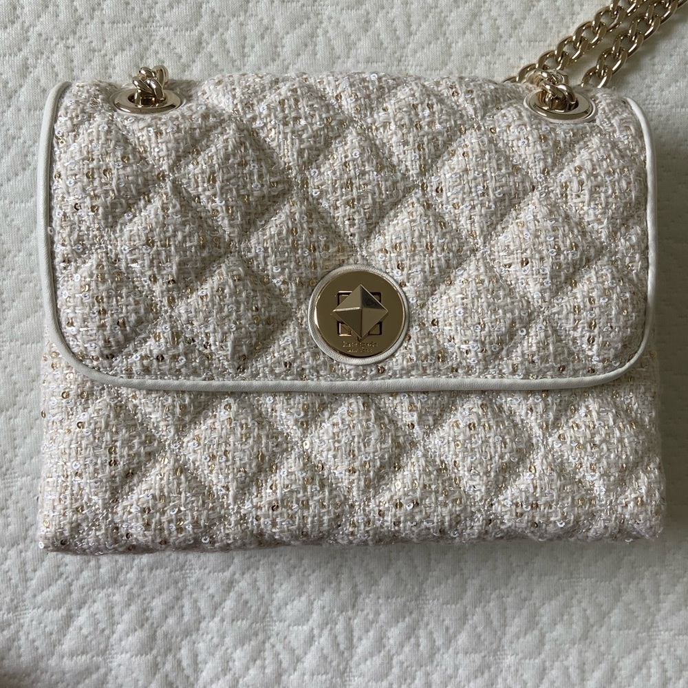 Small white Kate Spade purse. White with gold shimmer. New, but without tags.